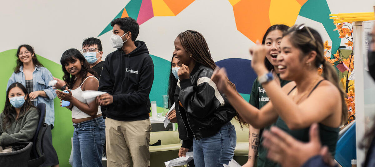 A group of people cheer and smile