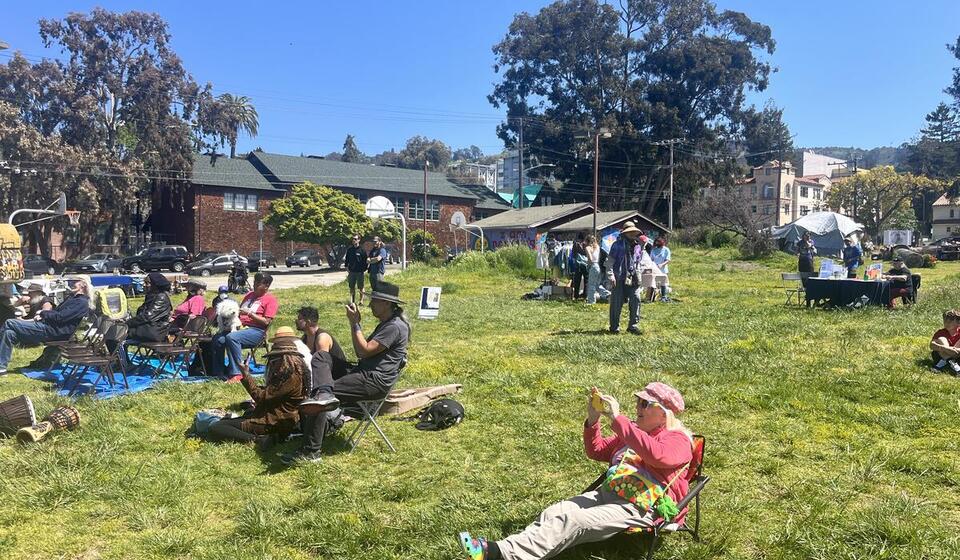 Groups of people lay on a grassy field